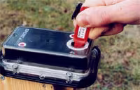 An electronic punch control box mounted beside a control stand